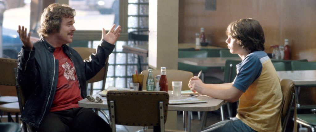 ALMOST FAMOUS, Philip Seymour Hoffman, Patrick Fugit, 2000.